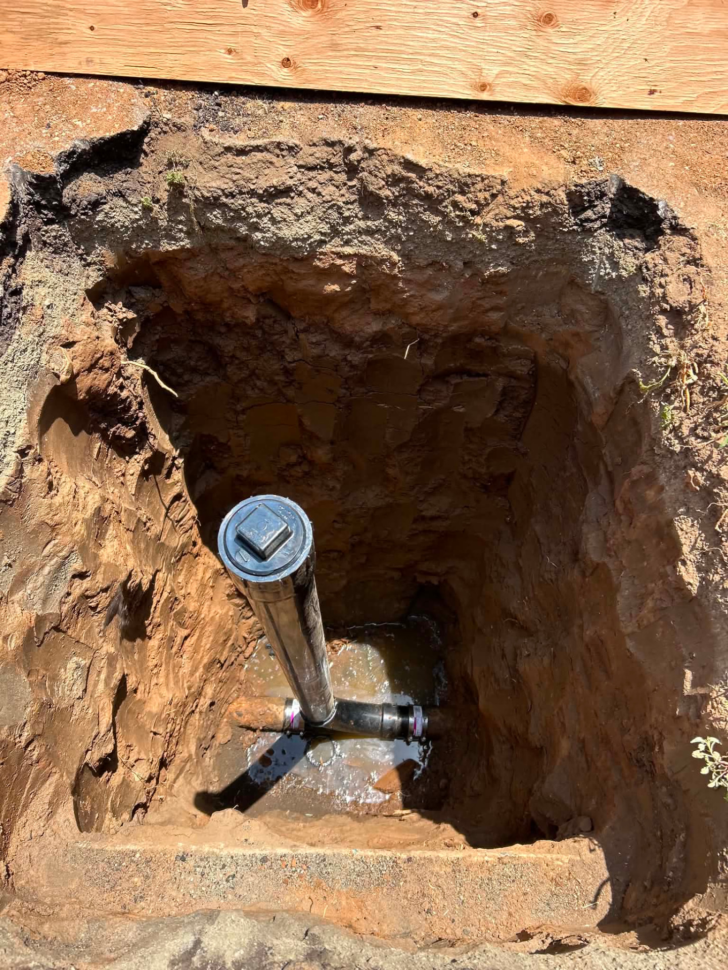 Excavated sewer cleanout with new riser and fittings installed